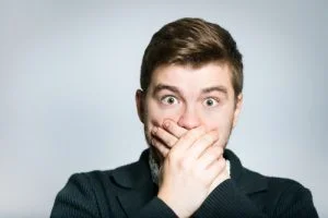Woman placing her hands on mouth